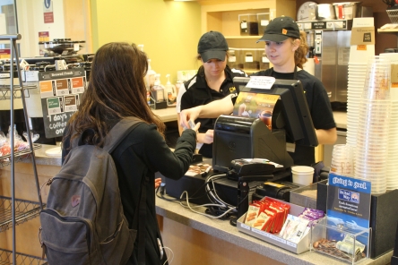 Barista Sarah Brown gives a customer her change at Java City in the Central Michigan University's Park Library on Oct. 17, 2017.